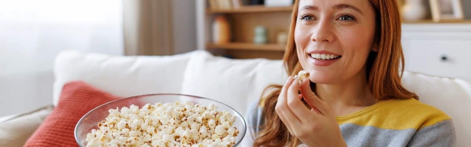 A person streaming entertainment at home with Bitcoin, Ether, and Litecoin icons